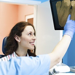 Patient and dentist looking at x-rays