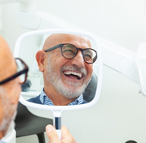 A man smiling at his repaired teeth