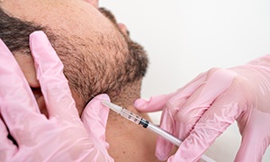 Man receiving BOTOX for his jaw pain