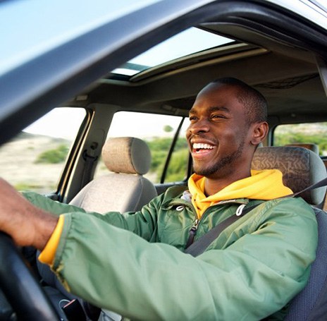 Man smiles while driving