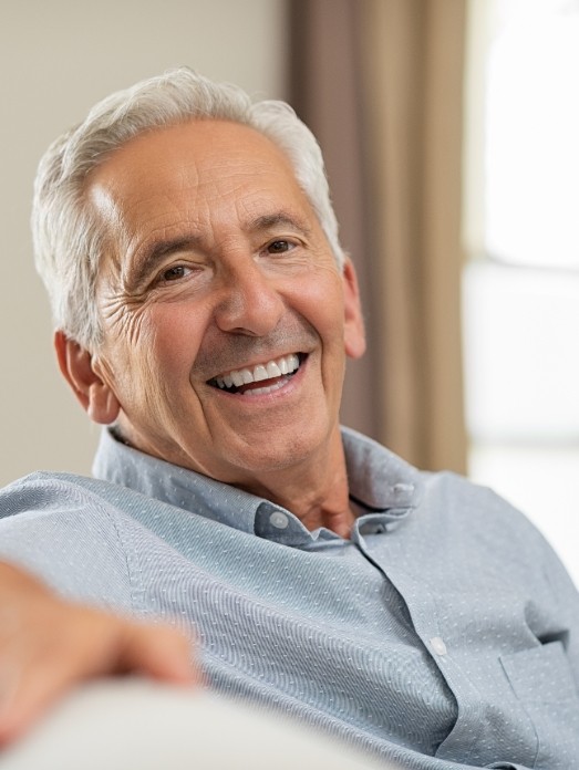 mature man talking to dentist about dentures  