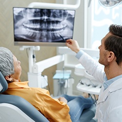 a dentist placing a dental implant in a patient’s mouth