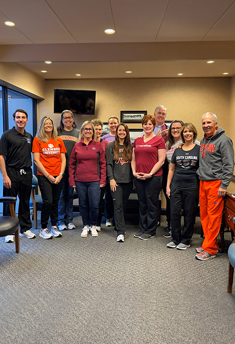 Rock Hill dental team members smiling in reception area