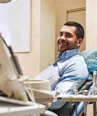 Male patient smiling in dental chair before IV sedation in Rock Hill, SC