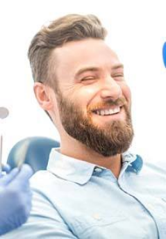 patient smiling while visiting cosmetic dentist 