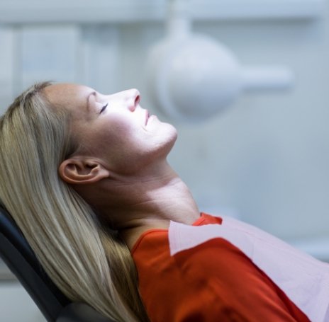 Woman receiving dental care under oral conscious sedation dentistry
