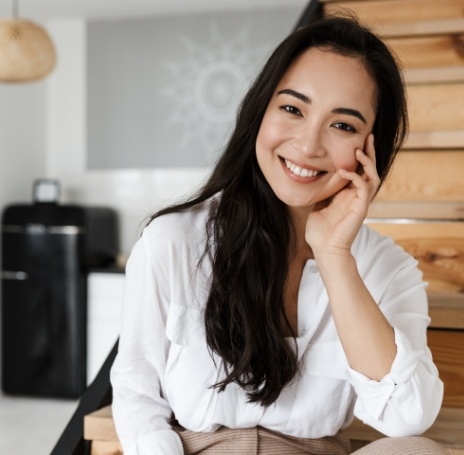 Woman in white collared shirt smiling