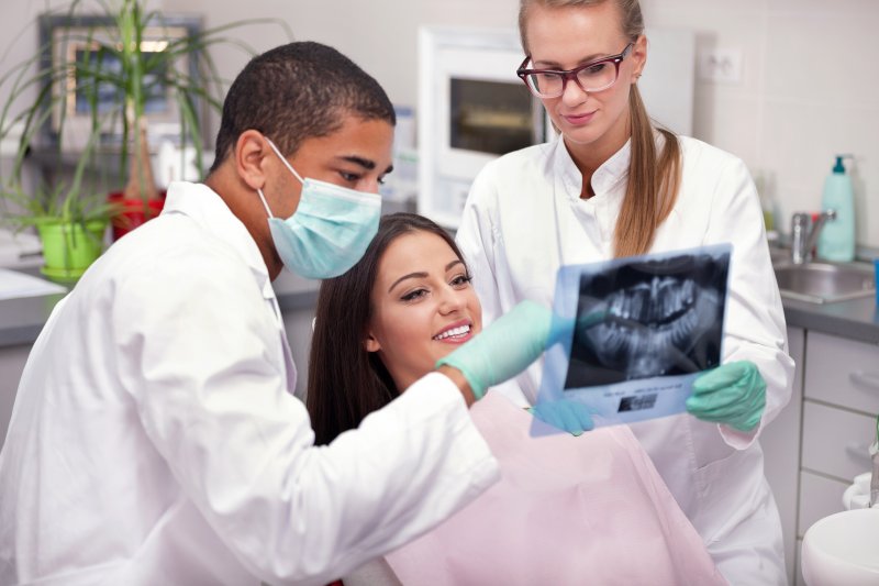 Dentist explaining TMD causes to a patient