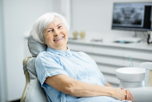 Woman smiling in patient’s chair