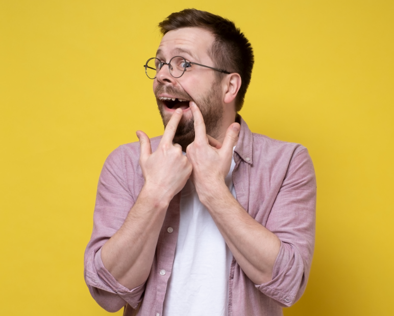 Man pointing at missing tooth