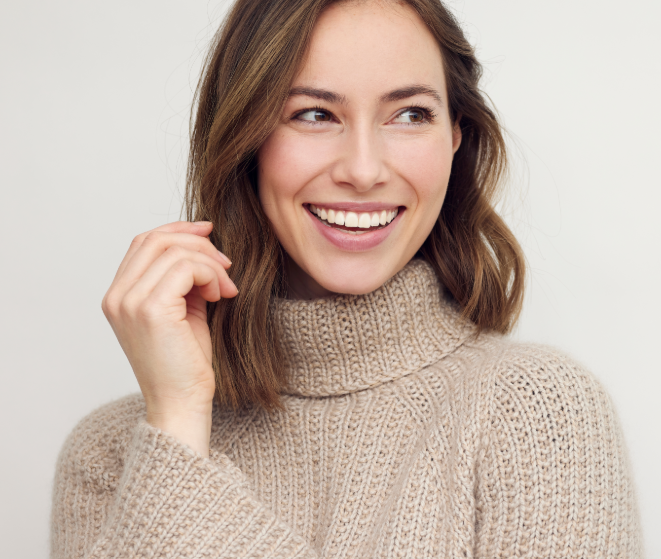 Woman in beige turtleneck, smiling